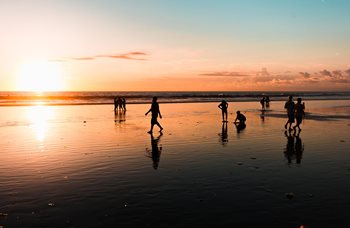 People on the beach at sunset