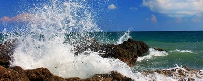 Wave breaking over rocks. Photo courtesy of Shutterstock