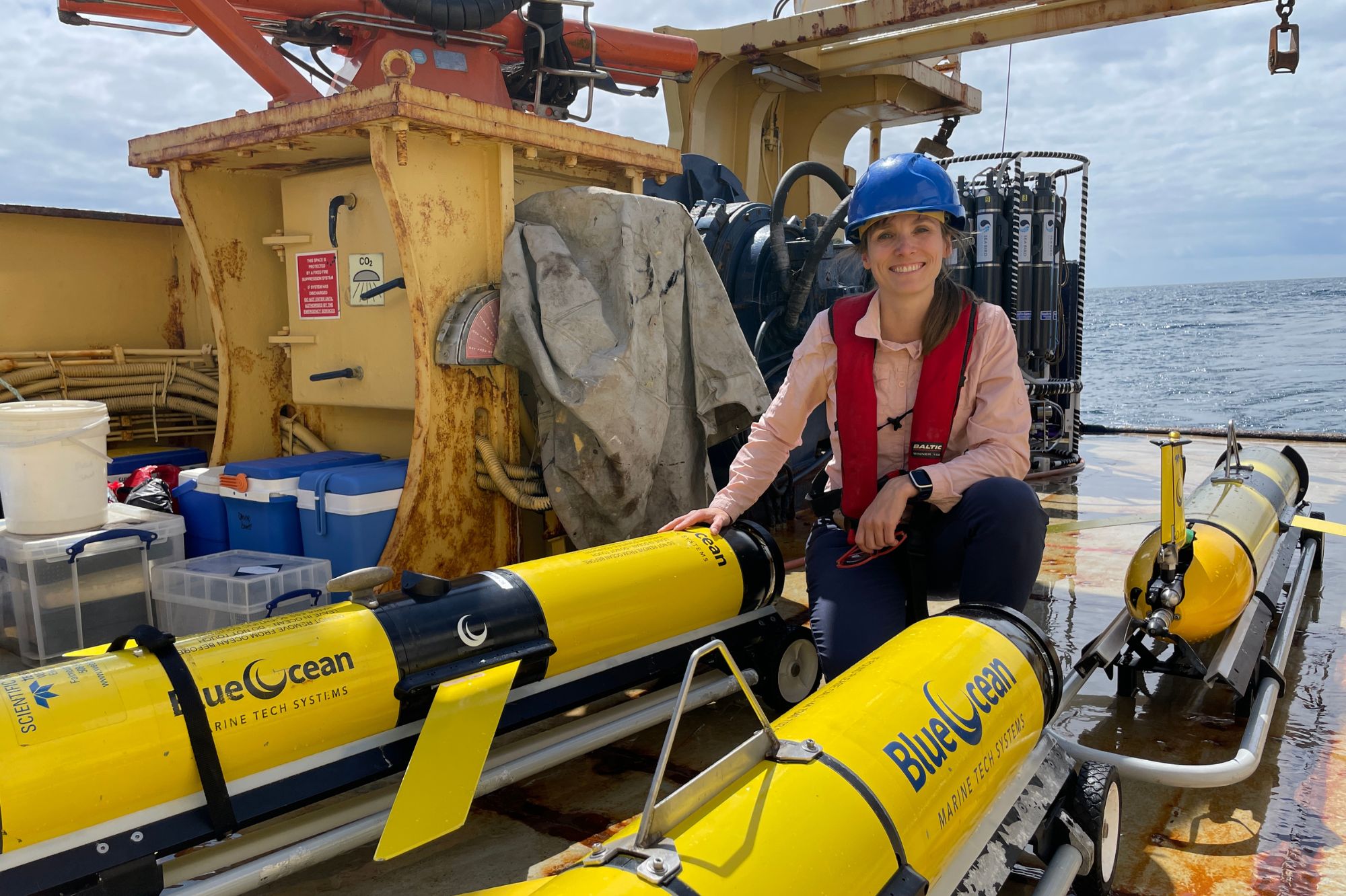 Image: Dr Juliane Wihsgott on board the PML Research Vessel Plymouth Quest alongside the 3 robotic gliders just prior to deployment. 