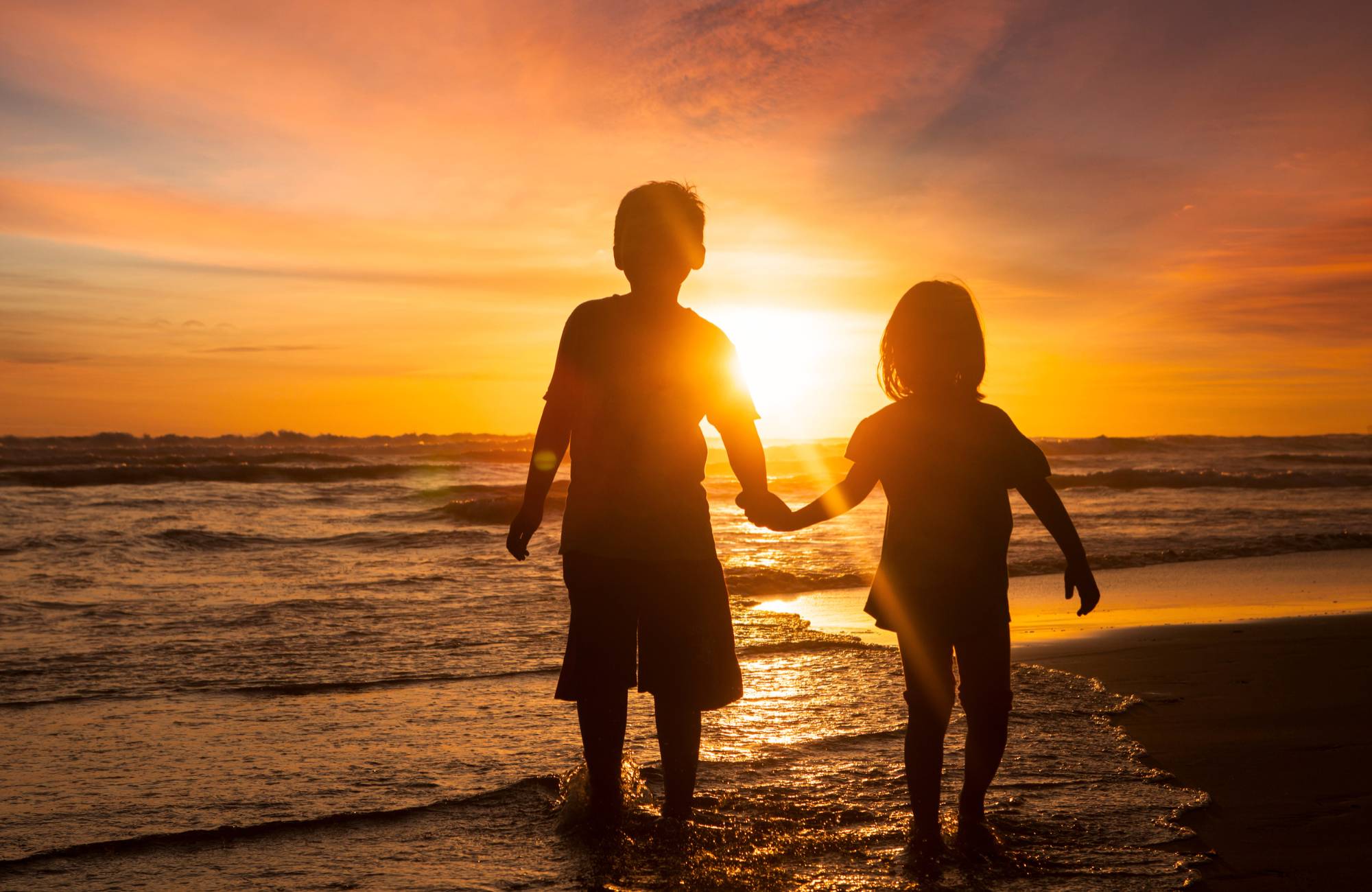 Children walking on a beach