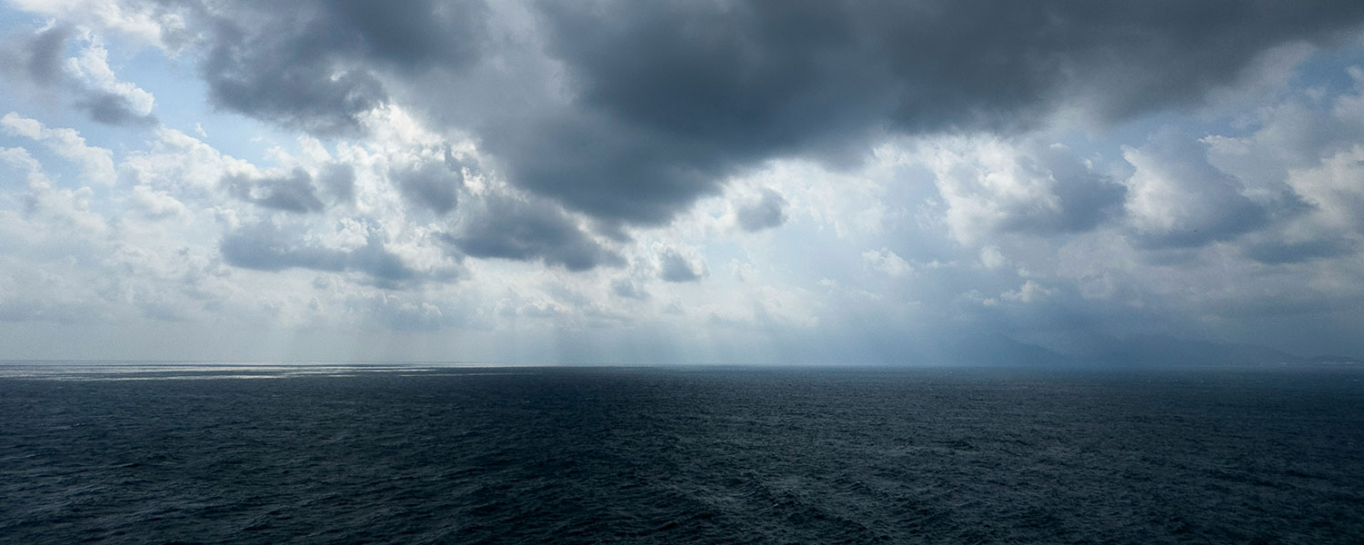 Dark sky with dark ocean surface and clouds