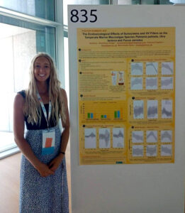 Anneliese alongside her research poster