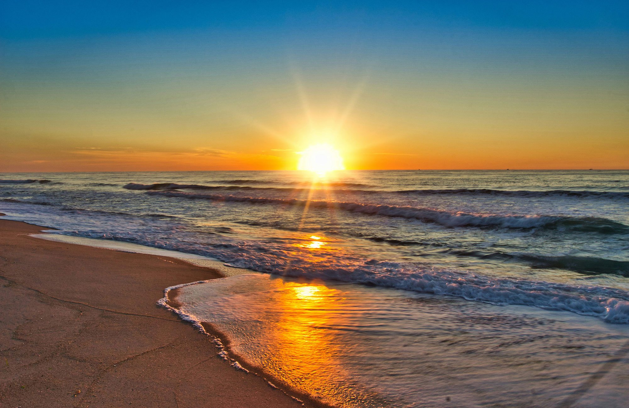 Sun setting over shoreline